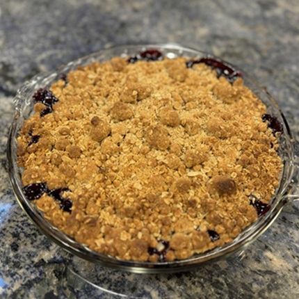 A cherry crumble made with oats in a glass dish
